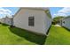 Exterior shot showcasing the side of the house with a green lawn at 1106 Carvello Dr, The Villages, FL 32162