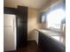 Modern kitchen with dark cabinets and tile floor at 431 N Boston Ave # B, Deland, FL 32724