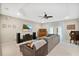 Living room with sectional sofa, hardwood floors, and a large TV at 227 Fort Florida Rd, Debary, FL 32713