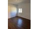 Bright bedroom featuring wood-look floors and a window at 612 E Plymouth Ave, Deland, FL 32724