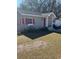 Gray house with red shutters, nicely landscaped yard at 612 E Plymouth Ave, Deland, FL 32724