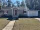 Charming house with red accents and a well-maintained lawn at 612 E Plymouth Ave, Deland, FL 32724
