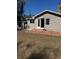 Tan house exterior with brick patio and detached shed at 612 E Plymouth Ave, Deland, FL 32724