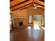 Living room featuring a stone fireplace and wood ceiling at 612 E Plymouth Ave, Deland, FL 32724