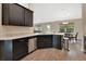 Modern kitchen with dark cabinetry, granite counters, and stainless steel appliances at 1322 Ferendina Dr, Deltona, FL 32725