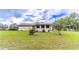 Landscaped backyard with a home featuring a sunroom at 3347 Quail Roost Dr, Deland, FL 32720