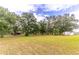 Spacious backyard with mature trees and a shed at 3347 Quail Roost Dr, Deland, FL 32720