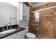 A bathroom featuring granite countertop vanity, cabinet, and tiled shower with glass door at 3428 Longleaf Rd, Ormond Beach, FL 32174