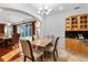 Elegant dining area with chandelier, tile flooring, and natural light from sliding glass doors at 3428 Longleaf Rd, Ormond Beach, FL 32174