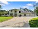 Spacious home featuring a large driveway, lush green lawn, and beautifully landscaped front yard at 3428 Longleaf Rd, Ormond Beach, FL 32174