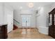 Grand foyer with tile flooring, chandelier, and elegant double doors leading to the main living area at 3428 Longleaf Rd, Ormond Beach, FL 32174