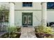 Elegant front entrance featuring decorative glass double doors, columns, and decorative tile walkway at 3428 Longleaf Rd, Ormond Beach, FL 32174