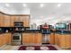 Well-equipped kitchen with wooden cabinetry, granite countertops, and stainless steel appliances, offering a functional layout at 3428 Longleaf Rd, Ormond Beach, FL 32174