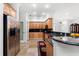 Well-lit kitchen featuring stainless steel appliances, granite countertops, and custom wood cabinetry at 3428 Longleaf Rd, Ormond Beach, FL 32174