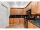 Traditional kitchen featuring wood cabinetry and granite countertops, complete with modern stainless steel appliances at 3428 Longleaf Rd, Ormond Beach, FL 32174