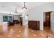 Spacious living room with tile flooring, leather furniture, and a carved wooden cabinet at 3428 Longleaf Rd, Ormond Beach, FL 32174