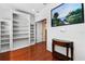 Home office featuring hardwood floor, a decorative painting, and built-in shelving at 3428 Longleaf Rd, Ormond Beach, FL 32174