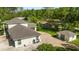 Rear exterior view of a well-maintained home with lush yard and separate garage at 3428 Longleaf Rd, Ormond Beach, FL 32174