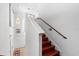 Bright staircase featuring hardwood stairs, white walls and trim, and a chandelier at 3428 Longleaf Rd, Ormond Beach, FL 32174