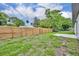 Large backyard with a new wooden fence at 210 E Baxter St, De Leon Springs, FL 32130