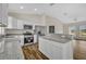 Open kitchen features white cabinets, stainless steel appliances, granite countertops and an open concept design at 210 E Baxter St, De Leon Springs, FL 32130