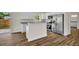 Modern kitchen featuring stainless steel appliances, granite countertops, and wood flooring with an open concept design at 210 E Baxter St, De Leon Springs, FL 32130