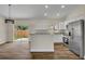 Bright kitchen with white cabinets, stainless steel appliances, granite countertops and sliding door to the backyard at 210 E Baxter St, De Leon Springs, FL 32130