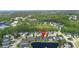 Aerial view of a community in a wooded area featuring single-Gathering homes near a pond at 309 Chesham St, Ormond Beach, FL 32174