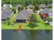 Aerial view of property with lush landscaping, screened-in porch, and waterfront view at 309 Chesham St, Ormond Beach, FL 32174