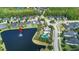 Aerial view of a community with a pool, roundabout, and single-Gathering homes near a pond at 309 Chesham St, Ormond Beach, FL 32174