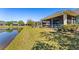 Backyard view featuring a tranquil pond and lush greenery extending from the covered patio at 309 Chesham St, Ormond Beach, FL 32174