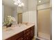 Bathroom boasts a double vanity with marble countertop and a glass-enclosed shower at 309 Chesham St, Ormond Beach, FL 32174