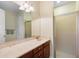 Bright bathroom with a long vanity, a large mirror, and a glass-enclosed shower at 309 Chesham St, Ormond Beach, FL 32174