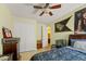 This bedroom features neutral-toned walls, a ceiling fan, and an open doorway leading to an en-suite bathroom at 309 Chesham St, Ormond Beach, FL 32174