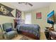 This well-lit bedroom features neutral-toned walls, a ceiling fan, and sports decor at 309 Chesham St, Ormond Beach, FL 32174