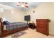 Cozy bedroom with a large TV, ceiling fan, and neutral tones at 309 Chesham St, Ormond Beach, FL 32174