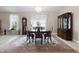 Formal dining room with elegant chandelier, a vintage hutch, and decorative rug at 309 Chesham St, Ormond Beach, FL 32174