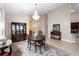 Open dining area features decorative rug, chandelier, and dining table with seating at 309 Chesham St, Ormond Beach, FL 32174