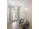 Inviting entryway featuring tiled floors, a decorative front door, and a charming seating area at 309 Chesham St, Ormond Beach, FL 32174