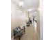 Hallway with tiled flooring, warm paint, and an inviting seating area with decorative touches at 309 Chesham St, Ormond Beach, FL 32174