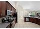 Featuring a well-equipped kitchen with granite countertops, stainless steel appliances, and ample cabinet space at 309 Chesham St, Ormond Beach, FL 32174