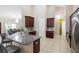 Bright kitchen showcasing a granite countertop island with breakfast bar and stainless steel appliances at 309 Chesham St, Ormond Beach, FL 32174
