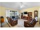 Inviting living room featuring a large sliding glass door and plush furniture for relaxing at 309 Chesham St, Ormond Beach, FL 32174