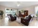 Comfortable living room features leather reclining chairs, neutral walls, and lake views at 309 Chesham St, Ormond Beach, FL 32174