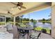 Inviting covered patio with serene lake views, comfortable seating, and screened-in enclosure at 309 Chesham St, Ormond Beach, FL 32174