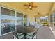 A beautifully furnished screened-in patio with lake view and ceiling fans, perfect for relaxing outdoors at 309 Chesham St, Ormond Beach, FL 32174