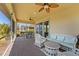 Covered patio features brick flooring, comfortable seating, and lovely views of the surrounding landscaping at 309 Chesham St, Ormond Beach, FL 32174