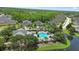 Aerial view of community pool with lush landscaping and comfortable lounge areas at 309 Chesham St, Ormond Beach, FL 32174