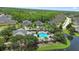 Aerial view of the community pool surrounded by lush landscaping and palm trees at 309 Chesham St, Ormond Beach, FL 32174