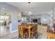 Bright dining area with wooden table and chairs, offering a view into the living room at 341 Perfect Dr, Daytona Beach, FL 32124